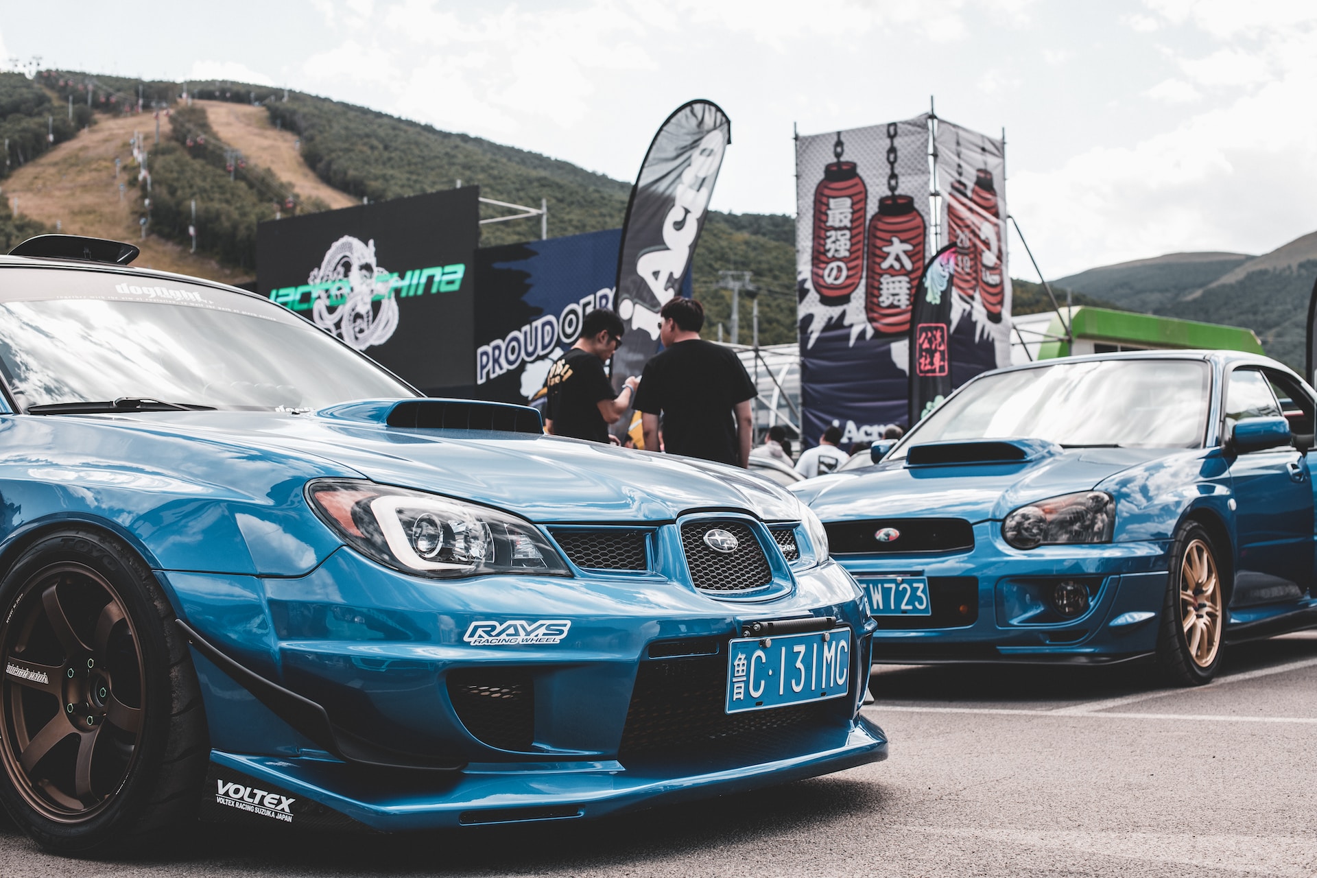 An image of two blue tuned cars