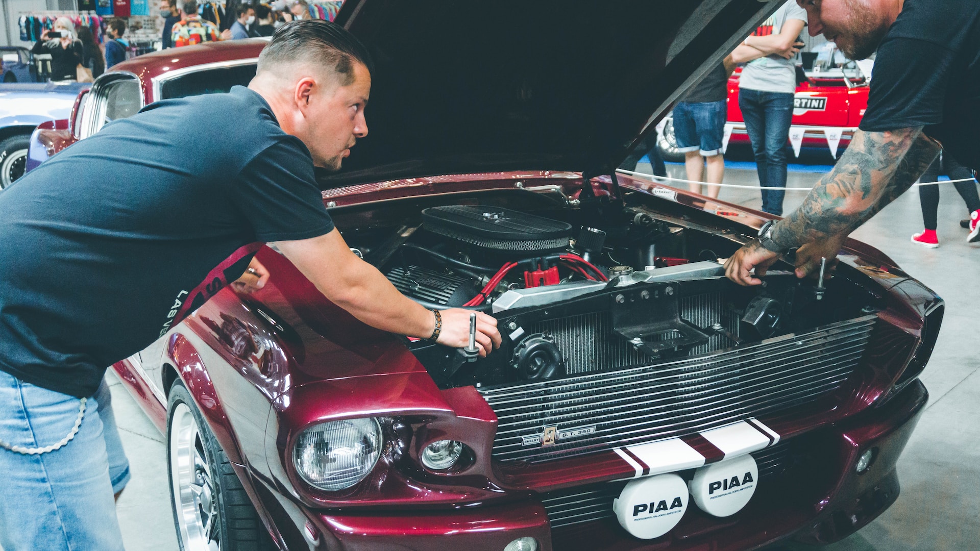 Two guys working on a car engine