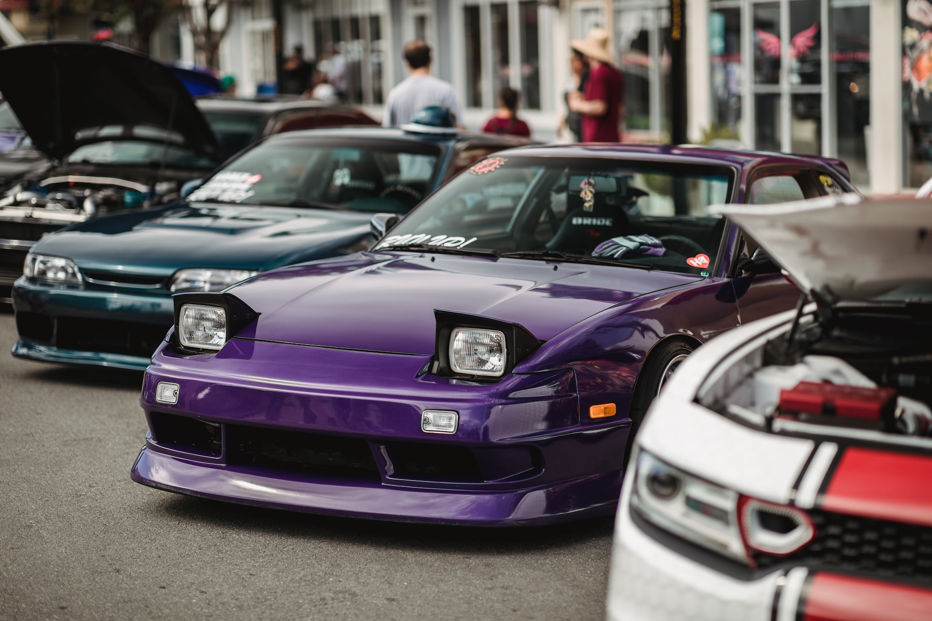 A purple sports car parked at an event